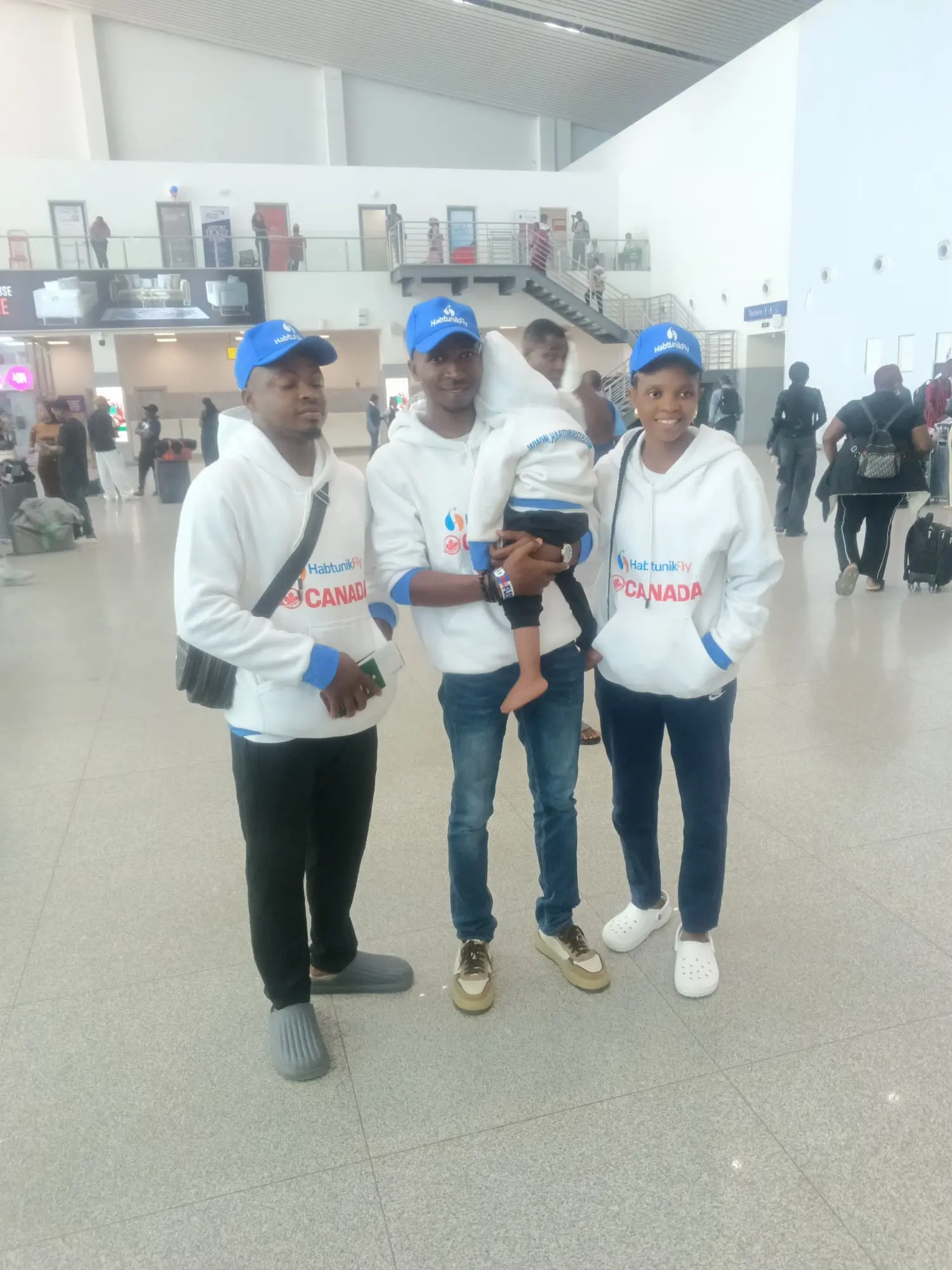 Family in HabtunikFly Canada hoodies and caps at the airport before departure