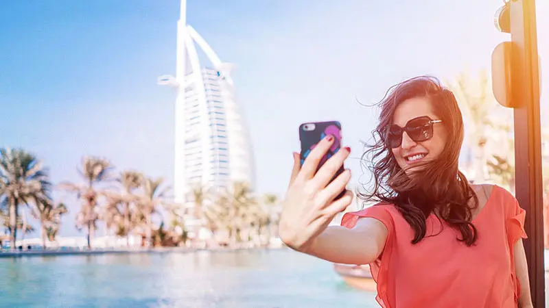 Traveller taking a selfie in front of the Burj Al Arab, Dubai