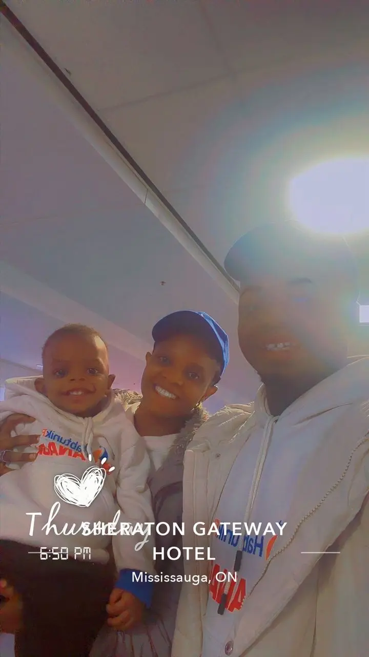 Family smiling together at the Sheraton Gateway Hotel, Mississauga, Ontario